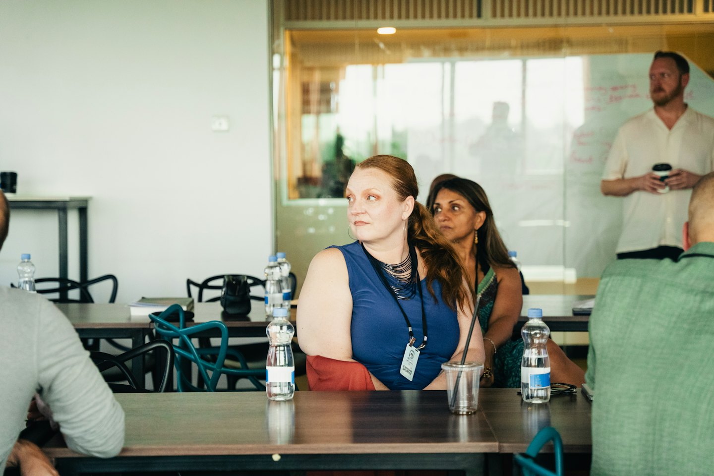 Professionals listen to a presentation in a modern office.