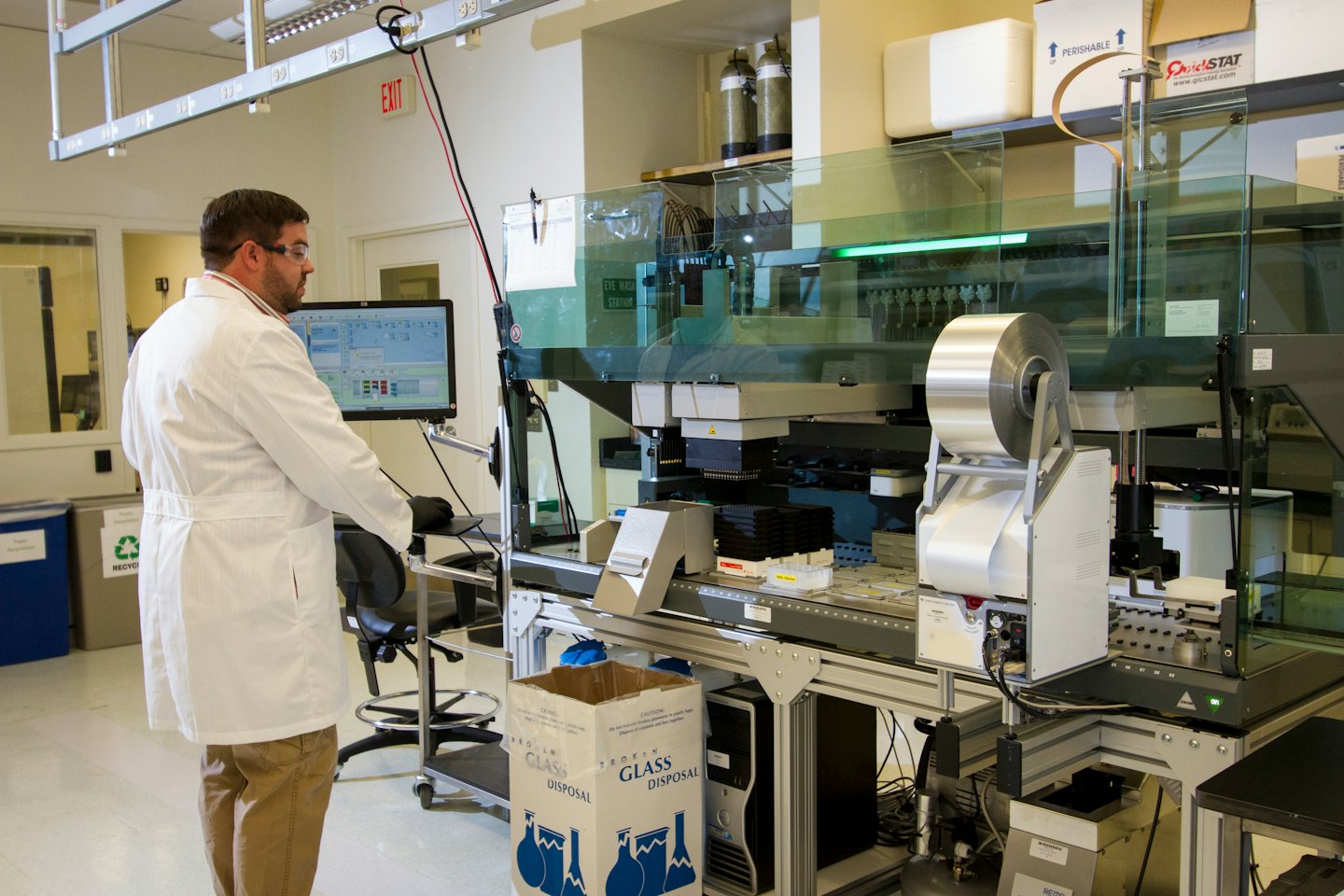 Scientist monitors automated machinery on a computer screen.